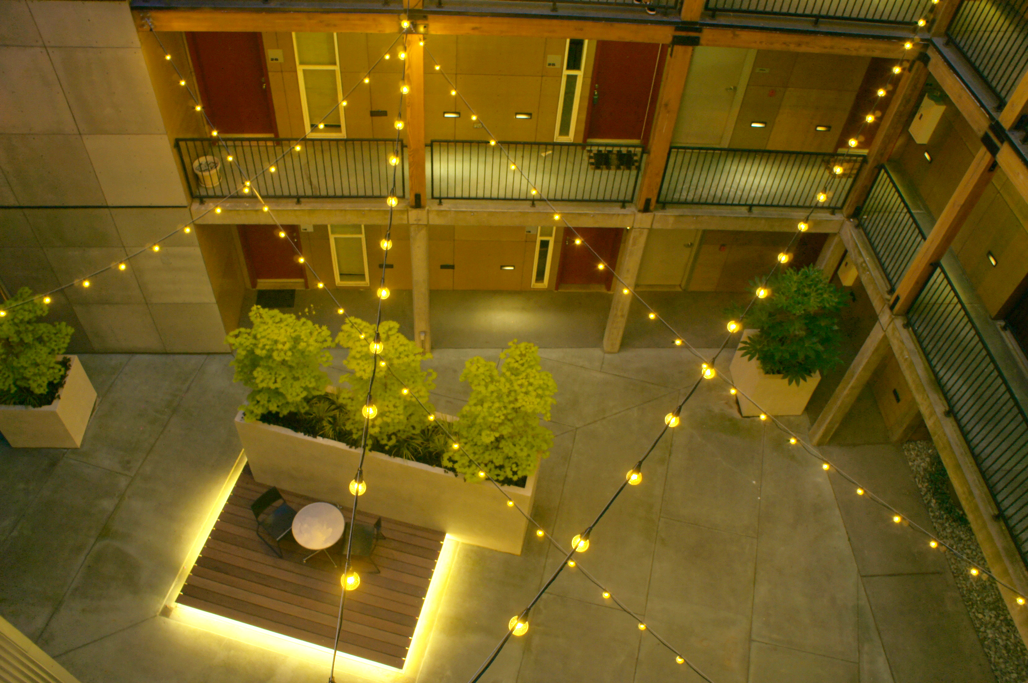 Bell-Seattle-bistro-strip-1 String lights line modern Seattle apartment complex
