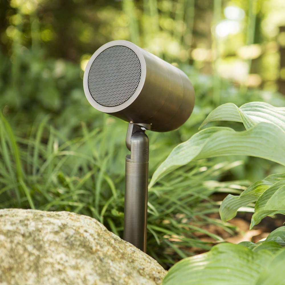 Bullet speaker hidden among foliage